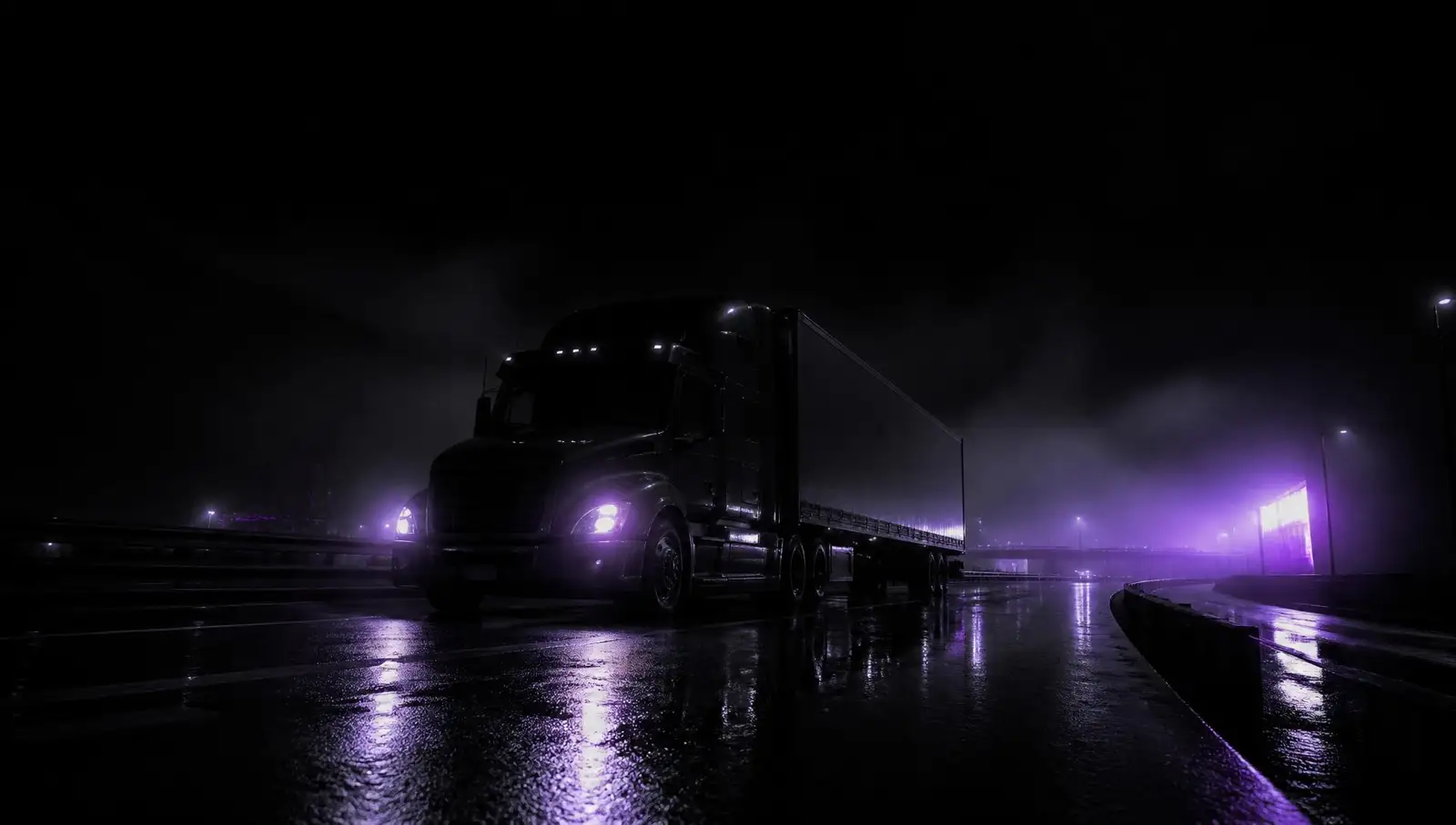Tractor-trailer running an interstate lane at night
